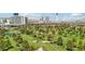 Stunning aerial view of a golf course and homes with mature landscaping, complemented by the vibrant Las Vegas skyline at 3177 Bel Air Dr, Las Vegas, NV 89109