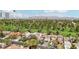 Aerial of neighborhood houses, golf course, and a partial view of the city and mountains in the background at 3177 Bel Air Dr, Las Vegas, NV 89109