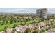 Neighborhood aerial view of houses with golf course views and city skyline in the distance at 3177 Bel Air Dr, Las Vegas, NV 89109