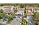 Aerial view of houses with tile roofs and a paved driveway lined by palm trees in a neighborhood by a golf course at 3177 Bel Air Dr, Las Vegas, NV 89109