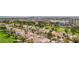 Expansive aerial view of homes nestled beside a golf course, with the Las Vegas cityscape in the background at 3177 Bel Air Dr, Las Vegas, NV 89109