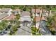Aerial view of homes with tile roofs and palm trees in a golf course community on a sunny day at 3177 Bel Air Dr, Las Vegas, NV 89109