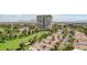 Overhead aerial view of homes next to a golf course with tree-lined streets, framed by the Las Vegas skyline at 3177 Bel Air Dr, Las Vegas, NV 89109