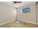 A cozy bedroom with tile flooring, a ceiling fan, and a mounted television at 3177 Bel Air Dr, Las Vegas, NV 89109