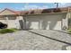 A two car garage with a brick paver driveway and desert landscaping at 3177 Bel Air Dr, Las Vegas, NV 89109