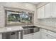 Kitchen with stainless steel farmhouse sink and backyard views from a large window, lots of natural light at 3177 Bel Air Dr, Las Vegas, NV 89109