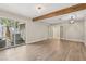 Bright living room featuring wood floors, recessed lighting, decorative wood beam, and sliding glass doors at 3177 Bel Air Dr, Las Vegas, NV 89109