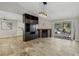 Spacious living room with an entertainment center, fireplace, and access to an outdoor patio at 3177 Bel Air Dr, Las Vegas, NV 89109