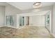 Open living area with tiled floors and multiple doors to outdoor atrium spaces, providing ample light at 3177 Bel Air Dr, Las Vegas, NV 89109