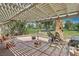 Large covered patio with red brick flooring and views of the golf course at 3177 Bel Air Dr, Las Vegas, NV 89109