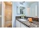 Charming bathroom with a granite countertop, double mirrors, and a shower with swan accents at 3332 Beca Faith Dr, North Las Vegas, NV 89032