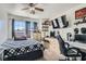 Bedroom with a plaid bedspread, large window and desk with shelving, creating an inviting atmosphere at 3332 Beca Faith Dr, North Las Vegas, NV 89032