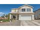 Charming two-story home with a well-maintained lawn and attached two-car garage at 3332 Beca Faith Dr, North Las Vegas, NV 89032