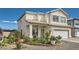 Inviting two-story home boasts of a well-manicured front yard with beautiful plants and a two-car garage at 3332 Beca Faith Dr, North Las Vegas, NV 89032