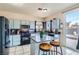 Well-equipped kitchen with modern appliances, granite countertops, an island, tile floors, and backyard views at 3332 Beca Faith Dr, North Las Vegas, NV 89032