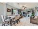 Open-concept living and dining area with built-in shelving and tile floors at 3332 Beca Faith Dr, North Las Vegas, NV 89032