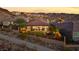 An aerial backyard view showing patio furniture, green lawn, and desert landscape at 35 Via Rizzuto, Henderson, NV 89011