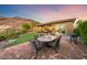 Charming outdoor dining area on patio, surrounded by lush greenery and scenic views at 35 Via Rizzuto, Henderson, NV 89011