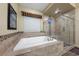 Bathroom features a tiled tub and a glass enclosed walk-in shower with a seat at 35 Via Rizzuto, Henderson, NV 89011