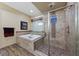 Bathroom showcasing a soaking tub and a separate glass-enclosed shower with mosaic tile accents at 35 Via Rizzuto, Henderson, NV 89011