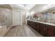 Spacious bathroom featuring a double vanity, large shower, and wood-look tile flooring at 35 Via Rizzuto, Henderson, NV 89011