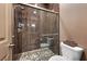 Modern bathroom featuring a walk-in shower with pebble flooring and stylish fixtures at 35 Via Rizzuto, Henderson, NV 89011