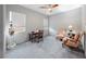 Bedroom with white walls and two windows, featuring two armchairs and a sewing machine desk at 35 Via Rizzuto, Henderson, NV 89011