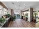 Open dining area with sliding glass doors leading to the backyard, ample plants, and stylish lighting at 35 Via Rizzuto, Henderson, NV 89011