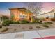 Well-maintained home with lush landscaping, retaining wall, and desert flora at 35 Via Rizzuto, Henderson, NV 89011