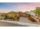 Charming single-story home with brick accents, lush landscaping, and a brick driveway at 35 Via Rizzuto, Henderson, NV 89011