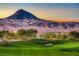 Picturesque view of a golf course with a mountain backdrop and clear blue sky at 35 Via Rizzuto, Henderson, NV 89011