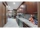 Hallway with built-in cabinets, granite countertops, wine fridge and a view to the office at 35 Via Rizzuto, Henderson, NV 89011