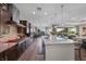 Gourmet kitchen featuring granite counters, stainless appliances, large island, and backyard views at 35 Via Rizzuto, Henderson, NV 89011