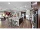 Modern kitchen with stainless appliances, granite counters, island with seating, and open to the living room at 35 Via Rizzuto, Henderson, NV 89011