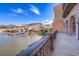 Balcony view overlooking a lake, with mountains and colorful building in the distance at 35 Via Rizzuto, Henderson, NV 89011
