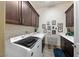 Well-lit laundry room with modern appliances, ample cabinet space, and charming decor at 35 Via Rizzuto, Henderson, NV 89011