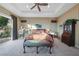 Bright main bedroom with backyard views, tray ceiling, and elegant furnishings at 35 Via Rizzuto, Henderson, NV 89011