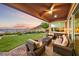 Inviting covered patio featuring comfortable seating and scenic mountain views at sunset at 35 Via Rizzuto, Henderson, NV 89011