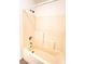 A full bathtub and shower features tile surround and updated fixtures at 3735 Sand Pier St, Las Vegas, NV 89147