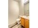 Half bath with wood vanity, bright lighting, toilet, and tile floors at 3735 Sand Pier St, Las Vegas, NV 89147