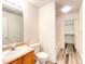 Bright bathroom featuring a single sink vanity, toilet, and a shower-tub combination at 3735 Sand Pier St, Las Vegas, NV 89147