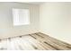 A bright bedroom featuring laminate wood flooring and a window with blinds at 3735 Sand Pier St, Las Vegas, NV 89147