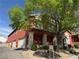 Charming two-story home with covered porch, red exterior, and beautiful landscaping at 3735 Sand Pier St, Las Vegas, NV 89147