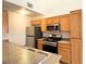 Well-lit kitchen features stainless steel appliances, wood cabinets and laminate countertops at 3735 Sand Pier St, Las Vegas, NV 89147