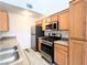 Bright kitchen features stainless steel appliances, wood cabinets and laminate countertops at 3735 Sand Pier St, Las Vegas, NV 89147