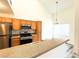 Bright kitchen featuring stainless steel appliances and wood cabinets with sleek countertops at 3735 Sand Pier St, Las Vegas, NV 89147