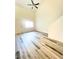 Bright living room with modern ceiling fan, wood flooring, and large window at 3735 Sand Pier St, Las Vegas, NV 89147