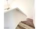 Carpeted stairs with railing and a modern light fixture above at 3735 Sand Pier St, Las Vegas, NV 89147
