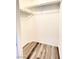 A walk-in closet with laminate wood flooring and shelving provides organized storage at 3735 Sand Pier St, Las Vegas, NV 89147