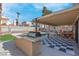 The backyard has a built-in grill, patio seating and artificial grass at 42 Megan Dr, Henderson, NV 89074
